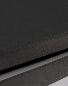 Black cardstock paper detail close up, thick craft paper board for diy handmade art.