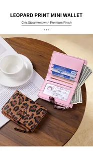 Close-up of leopard print mini wallet showing card slots and zipper pocket on wooden table.