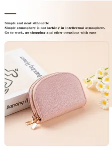 Detailed view of pink PU leather double zipper card wallet with floral prop and soft lighting.