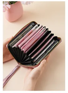 Pink glitter accordion long wallet with multiple card slots, zipper closure and wrist strap.