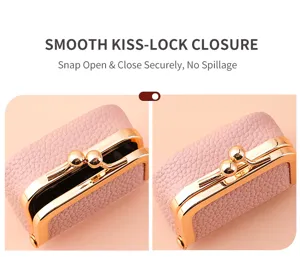 Detail view of mini pink leather kiss lock coin purse and jewelry box with gold metal clasp.