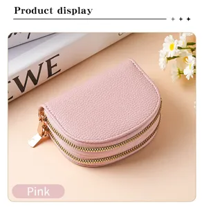 Detail view of the pink double zipper coin purse, showing compact accordion card storage.
