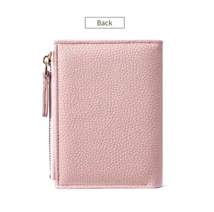 Pink women's short wallet with zipper pocket and litchi pattern leather design.