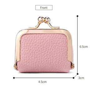 Mini pink kiss-lock coin purse and jewelry box detail shot showing compact dimensions.
