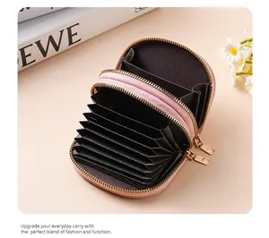 Pink double zipper accordion card holder with large capacity and multiple card slots inside.