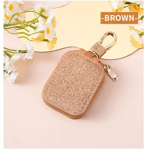 Custodia protettiva per auricolari bluetooth in paillettes marroni brillanti con gancio.