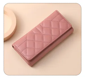 Detail view of the elegant pink quilted long wallet featuring a classic diamond pattern.