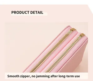 Detailed view of the women's pink double zipper wallet showcasing smooth gold metal teeth.