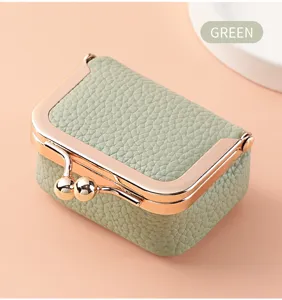 Mini green clasp jewelry box detail, cute leather coin purse texture, compact ring storage case.