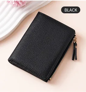Detail shot of black lychee grain wallet, compact bi-fold design with zipper pocket.