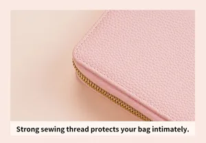 Close-up of pink women wallet detail showing premium leather texture and neat stitching lines.