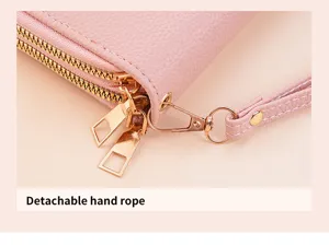 Close-up detail view of pink women double zipper wallet with a detachable strap in pink