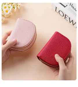 Detail shot of dual zipper coin purses and card holders in vibrant pink and red colors.