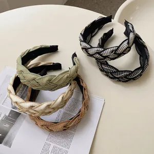 Close-up of braided wide headbands with gold chain accents in multiple colors