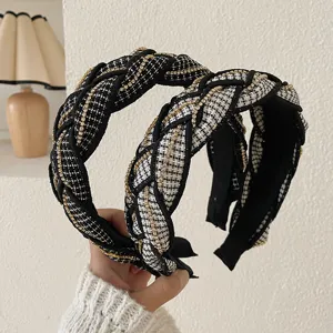Detailed view of braided tweed headbands with gold chain accents for high top hair style.