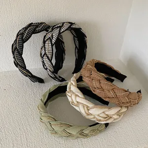 Detailed view of braided wide headbands with elegant gold chain accents in various colors