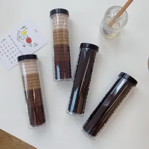 Detailed view of milk tea colored hair ties packed in portable transparent tubes
