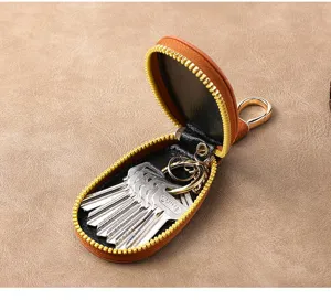 Brown leather key case zipper holder compact organizer for car keys with metal ring setup.