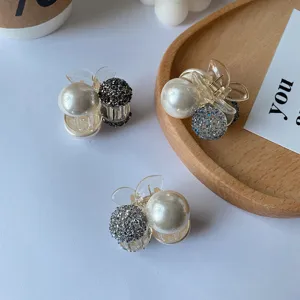 Detail view of Korean style small hair claw clips featuring faux pearls and crystals