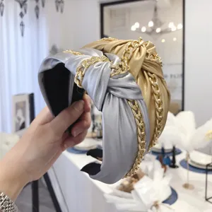 Stylish PU leather knotted headband with gold chain detail in gold and silver colors.