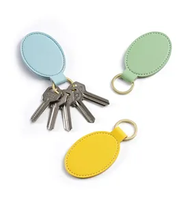 Llavero de cuero PU ovalado minimalista anillo de llave moda colgante logo para mujer y hombre