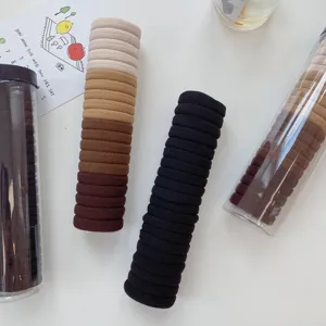 Detail view of elastic towel hair ties set in neutral earth tones and classic black