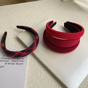 Set of vintage red velvet and plaid headbands on a white minimalist background
