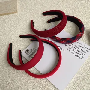 Variety of red vintage high-top headbands with solid and plaid patterns for Christmas.