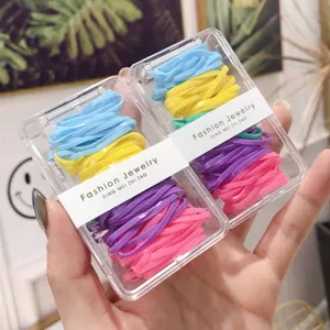 Close-up of vibrant colorful hair elastics in transparent gift boxes