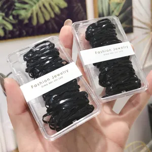 Detail view of black elastic hair bands packed in transparent plastic boxes