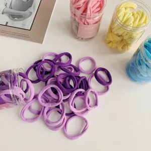 Detailed view of assorted colorful elastic hair bands in transparent storage jars