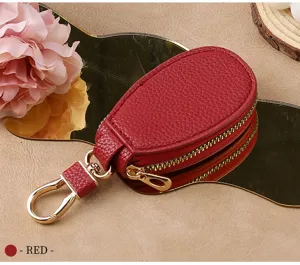 Red leather car key case with gold zipper and hook, compact minimalist design for daily use.