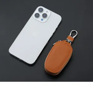 Brown leather car key case with metal zipper and waist hanging ring for daily use convenience.
