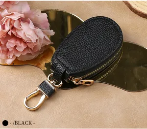Black leather car key pouch with gold hardware, zipper closure and metal hook for daily use.