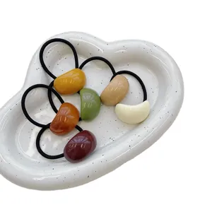 Colorful jelly acrylic hair ties with elastic bands displayed on a white cloud tray