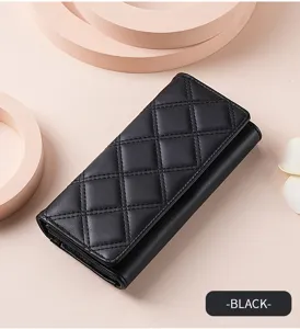 Detailed view of the elegant black quilted long wallet featuring fine stitching and texture.