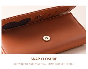 Close-up detail of brown trifold leather wallet showing snap closure and card slots.