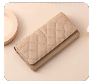 Detailed view of the elegant beige quilted long wallet, showcasing fine stitching craftsmanship.