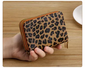 Leopard print mini wallet card holder detail shot showing double zipper structure and compact design.