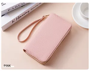 Close-up detail of a pink double zipper PU leather wallet with a convenient wrist strap.