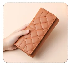 Quilted long wallet detail showcasing brown leather texture and large storage capacity.