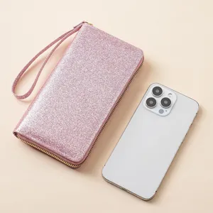 Stylish pink glitter long wallet for women with wrist strap and secure zipper closure.
