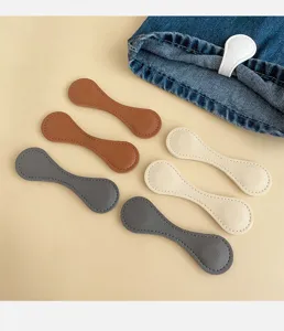 Detailed view of colorful magnetic leather clips for shortening pant hems and sleeves.