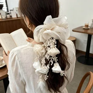 Dreamy beige organza floral tassel scrunchie perfect for an elegant Bohemian hair look