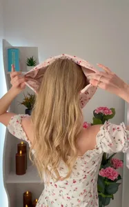 Back view of a floral waterproof shower cap worn over long hair for dry hair protection