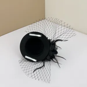 Close-up detail view of the underside of a black mesh fascinator hat with hair clips