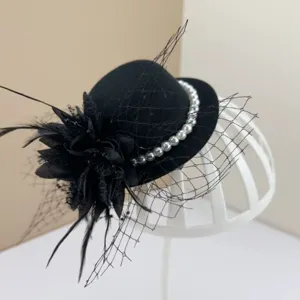 Vintage black fascinator hat with mesh veil, feathers and pearls for party events
