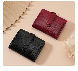 Close-up detail shot of women's short folding wallet with card slots and snap button.