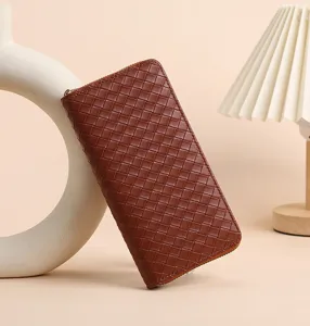 Details of brown woven long women wallet with zip closure and multiple card slots.