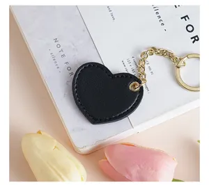 Black heart leather keychain with gold chain, cute bag pendant and car key accessory for daily use.